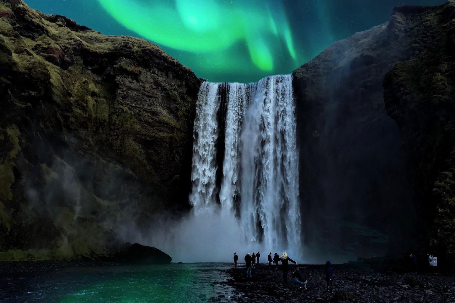 Group of people standing at the bottom of Skogafoss in Iceland