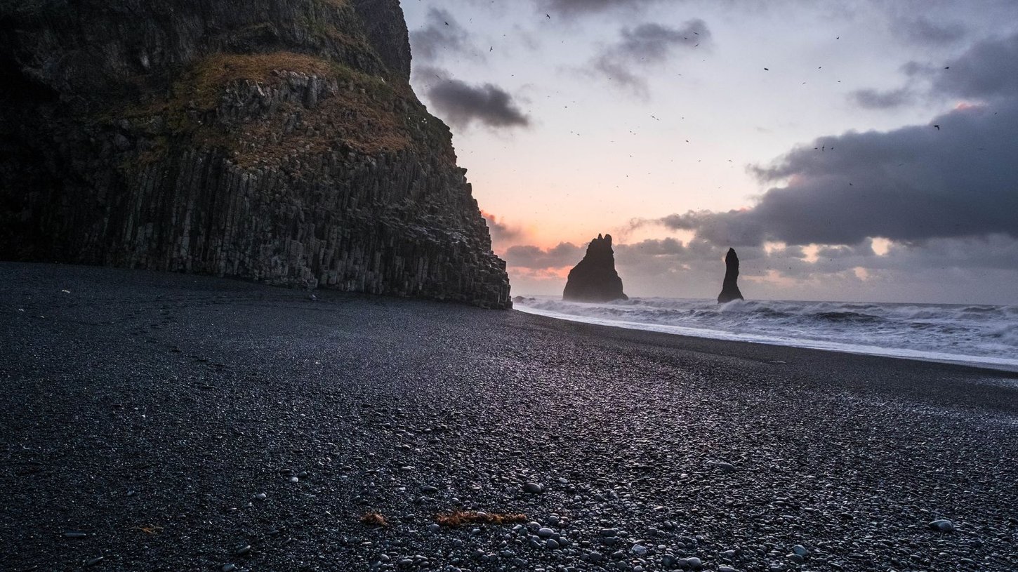 Reynisfjara black sand beach cliffs.