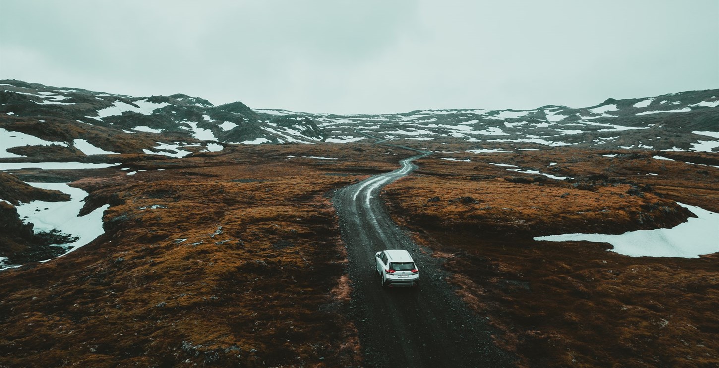 Aerial view of a rental car driving on F-Roads in Iceland