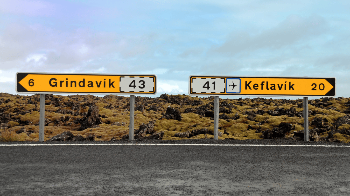 Signposts in Iceland pointing in opposite directions to Grindavik and Keflavik.