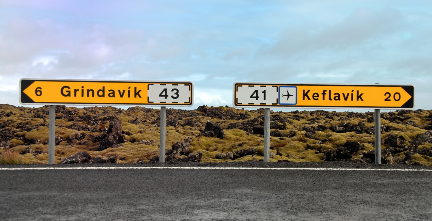 Signposts in Iceland pointing in opposite directions to Grindavik and Keflavik.