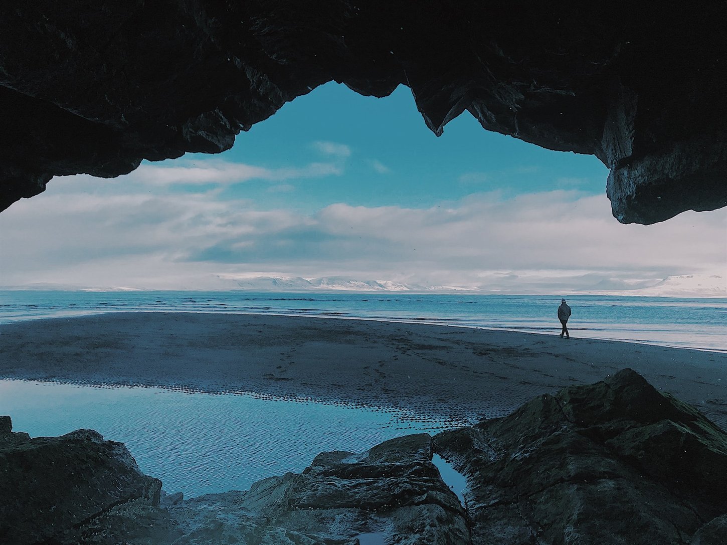 Solo traveller walking on a beach in Iceland