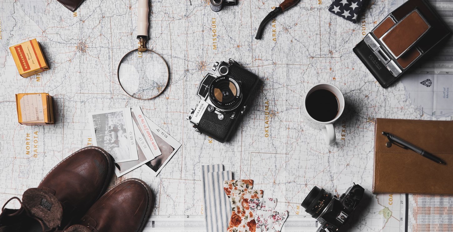 Array of travel blog equipment laid out on a map.
