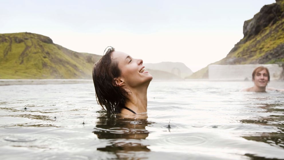 Woman swimming in a geothermal pool in Iceland. 