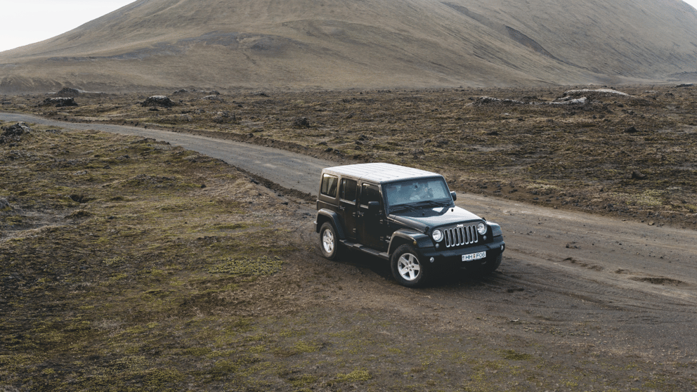 Jeep parked on the rugged terrain in Iceland