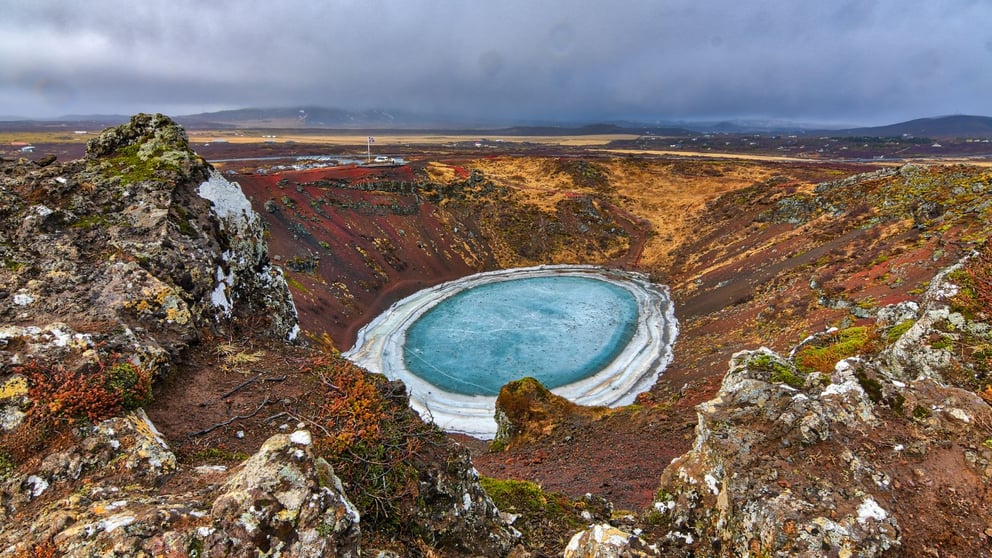 Kerid Crater Lake frozen over in the winter.