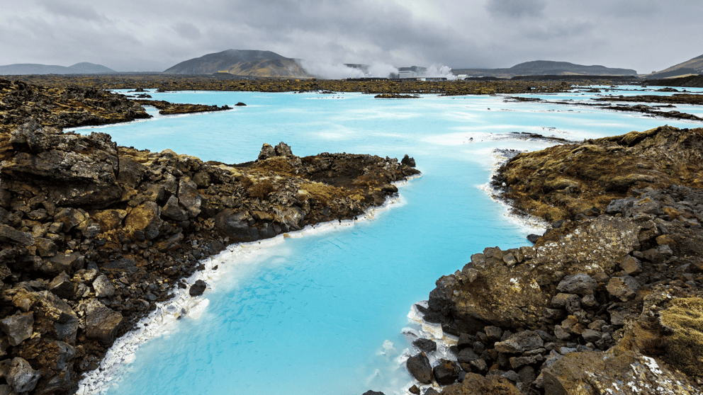 Blue Lagoon with black lava field in the background.