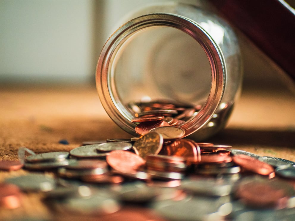 Tipping jar with coins. 