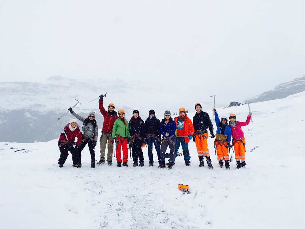 Group of people stood on a snowy mountain