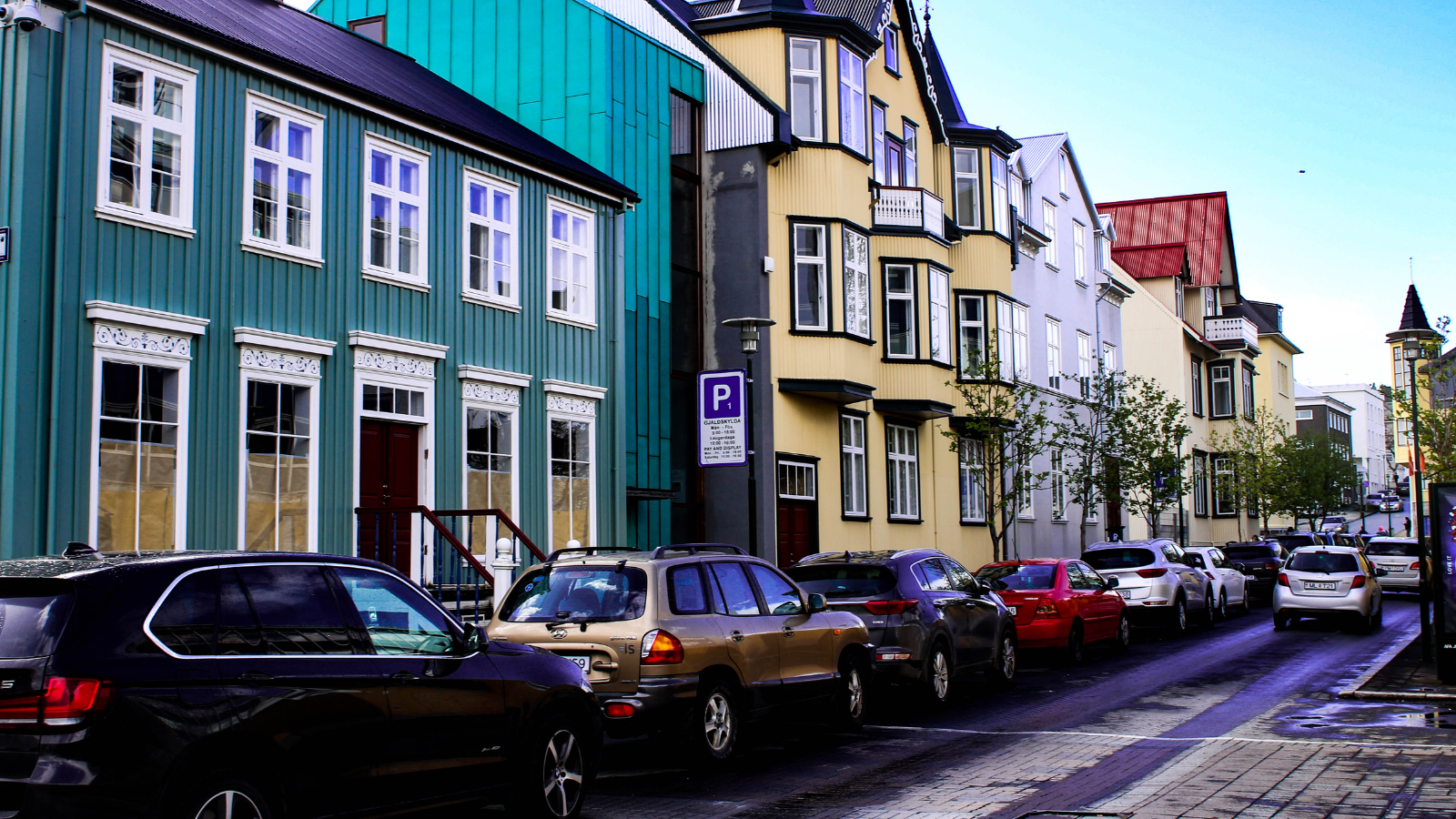 A line of cars parked on the roadside in Reykjavík