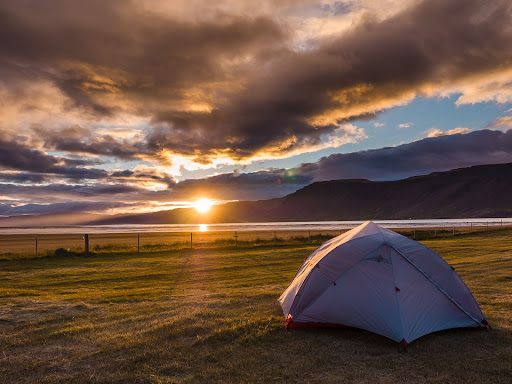 Tent pitched on a field in Rauðisandur, Iceland