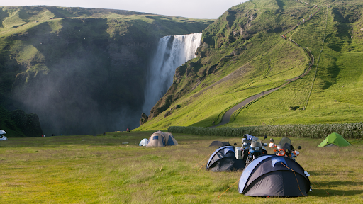 Tents pitched near a waterfall in Iceland 
