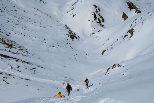 Family hiking through snow in Reykjadalur, Iceland
