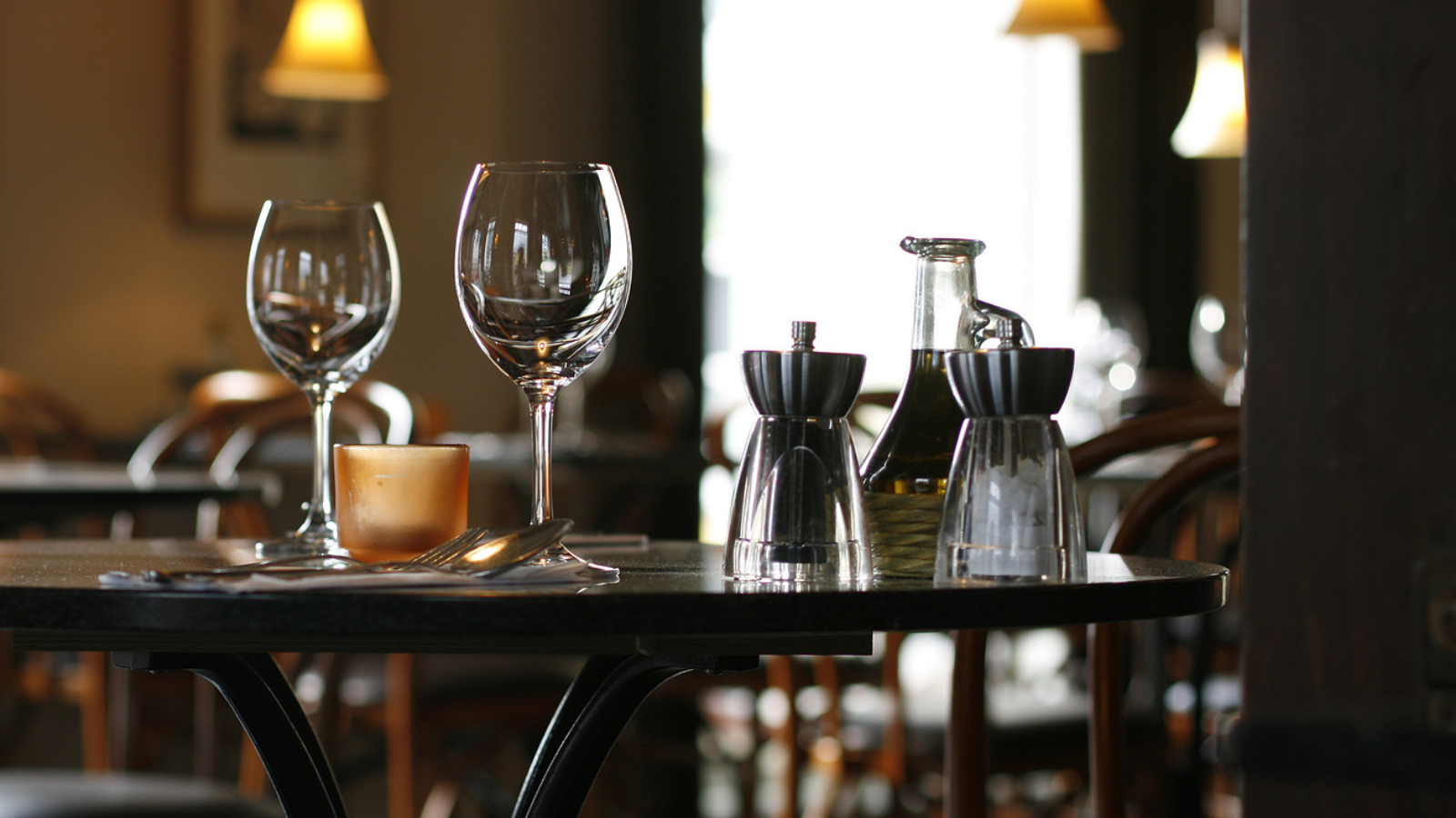 Wine glasses on a table in a restaurant.