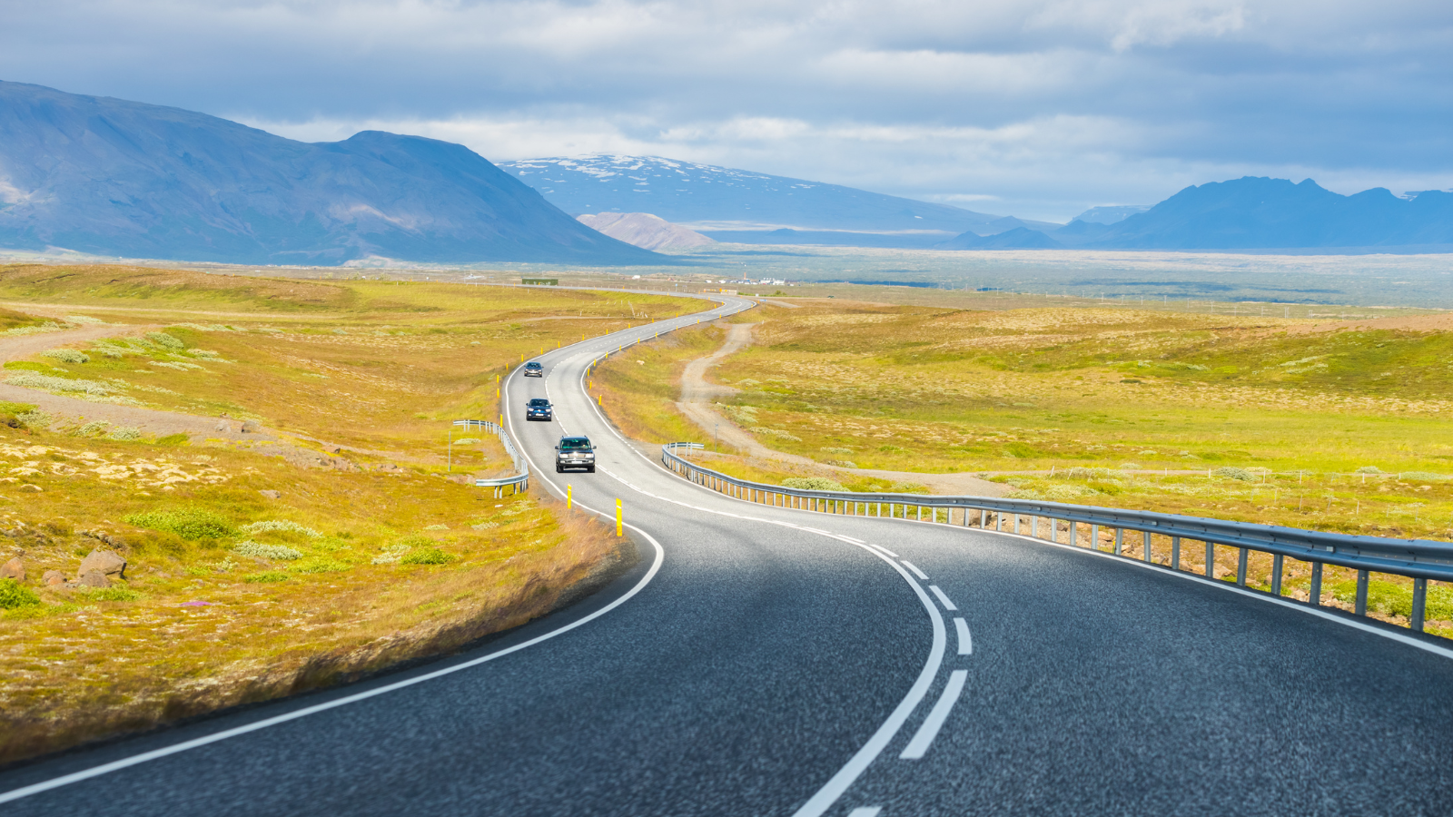 A road winding around mountains in southern Iceland in summer.