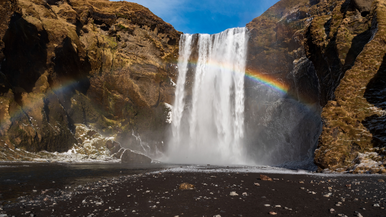 Skógafoss waterfall with a rainbow reflected in the spray.Skógafoss waterfall with a rainbow reflected in the spray.