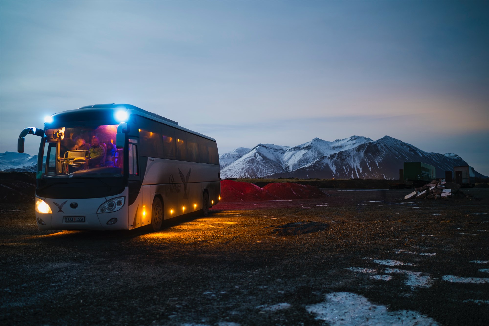 A coach on one of Iceland’s tracks with a snowy mountain in the distance.