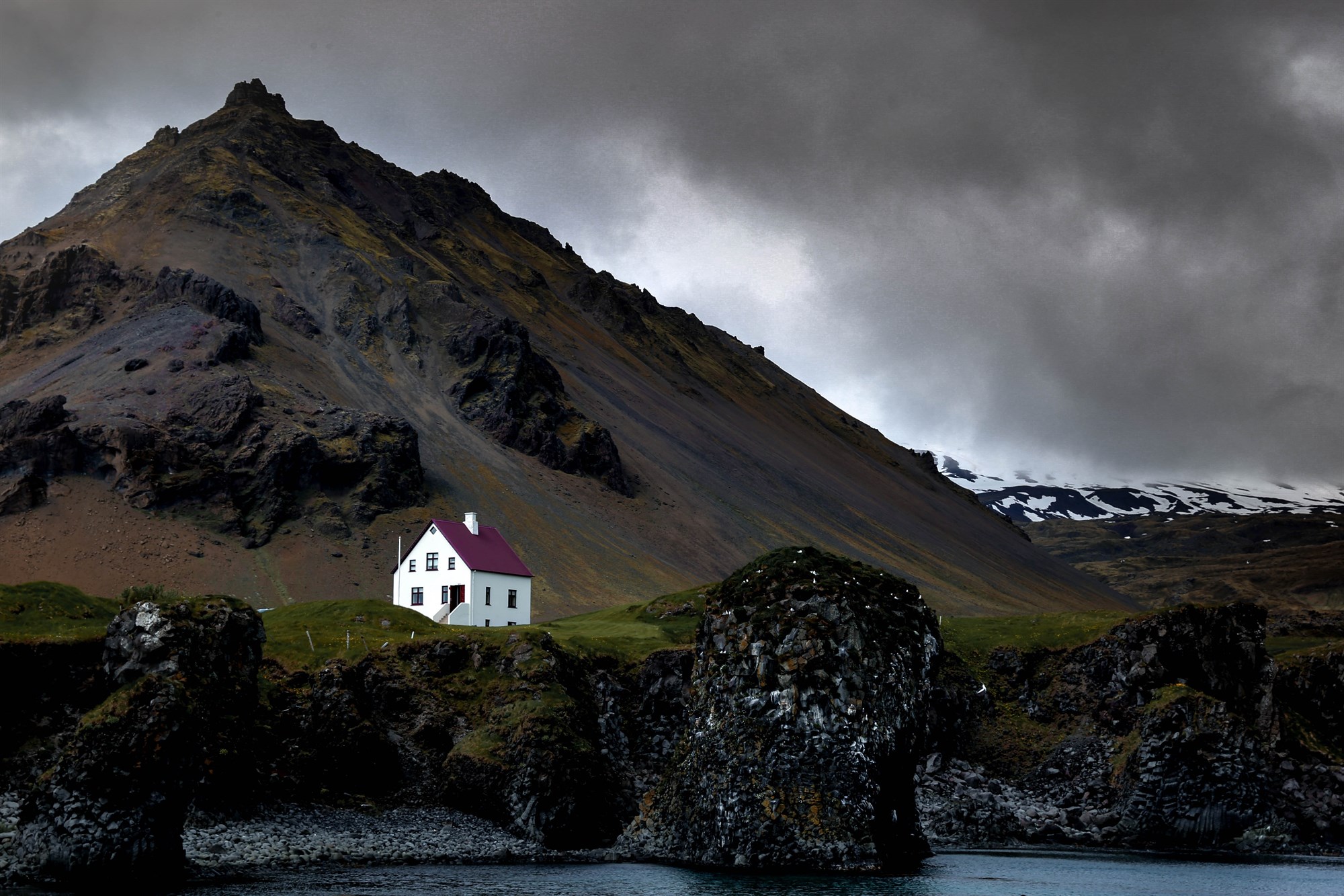 Small house on a cliff edge in the Westfjords in Iceland.