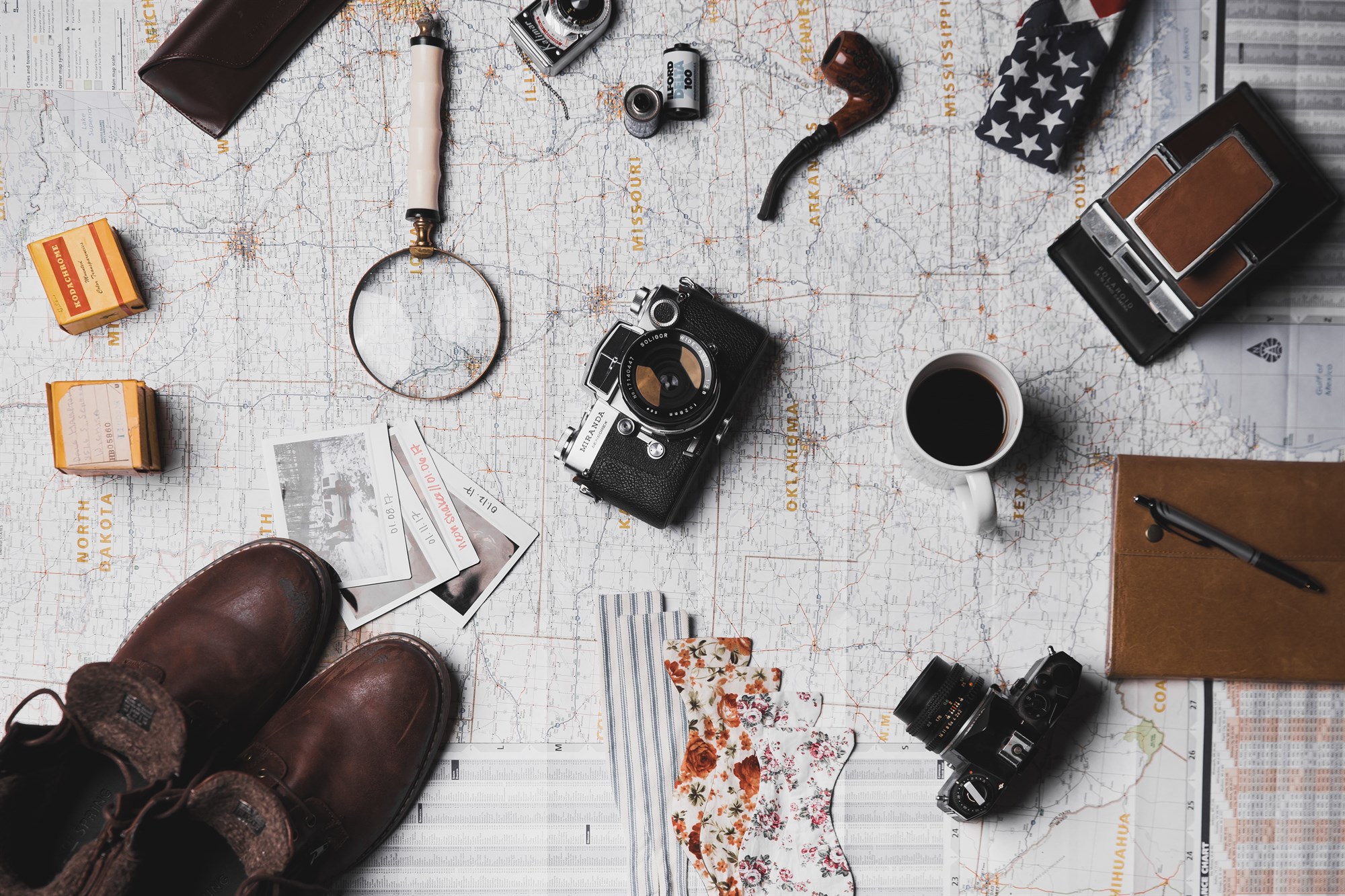 Array of travel blog equipment laid out on a map.