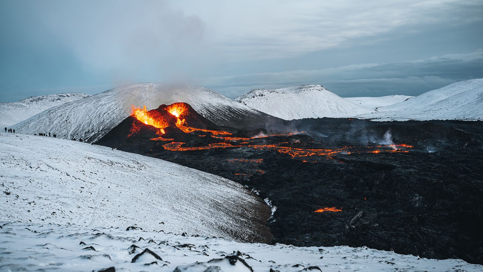 Lava flow in Iceland surrounded by snow.